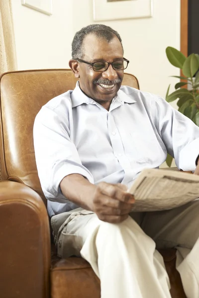 Senior Man Sitting In Armchair Reading Newspaper — Stock Photo, Image