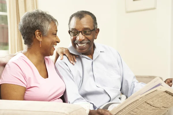 Senior Couple Reading Newspaper At Home — Stock Photo, Image