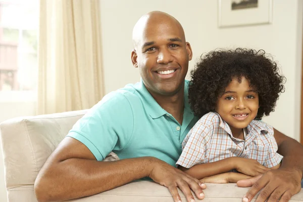 Father And Son Relaxing On Sofa At Home — Stock Photo, Image