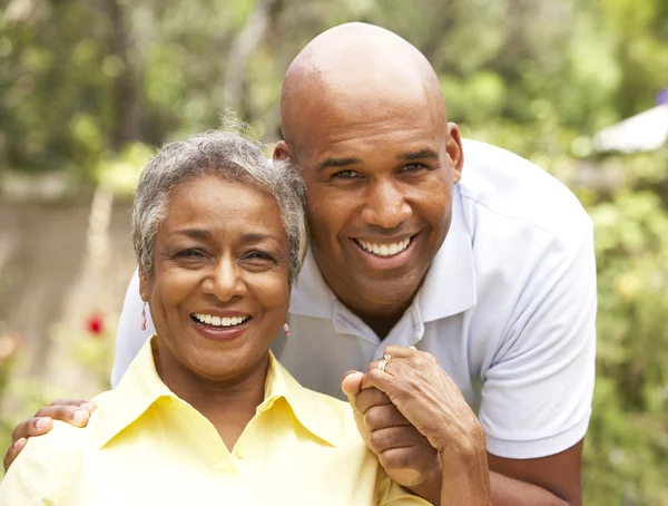 Senior Woman Being Hugged By Adult Son — Stock Photo, Image