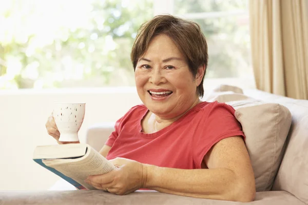 Senior Woman Reading Book Drink Home — Stock Photo, Image