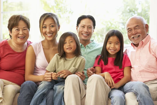 Extended Family Relaxing On Sofa At Home Together — Stock Photo, Image