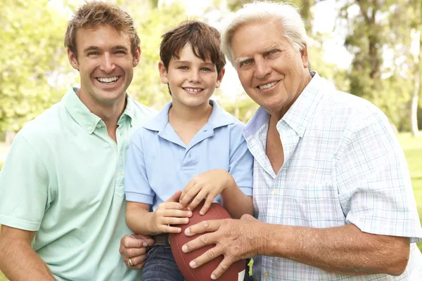 Grandfather With Father And Son Playing American Football Togeth Stock Image