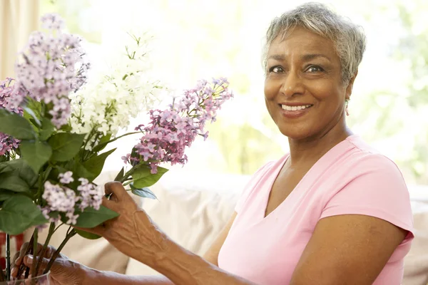 Senior Woman Flower Arranging Home Stock Image