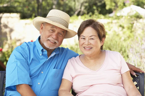 Senior Couple Relaxing In Garden Together Stock Image