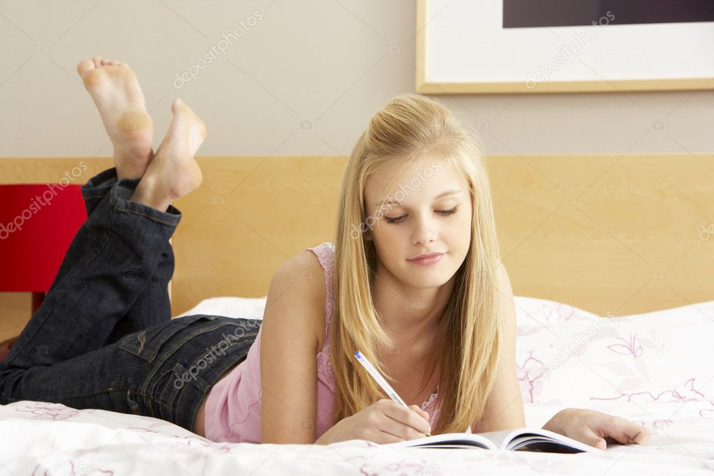 Teenage Girl Writing In Diary In Bedroom — Stock Photo © monkeybusiness ...