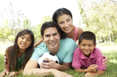 Family In Park With Football clipart