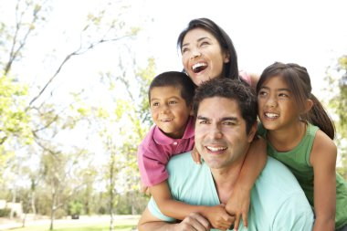 Young Family In Park clipart