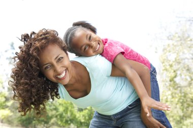 Portrait of Happy Mother and Daughter In Park clipart