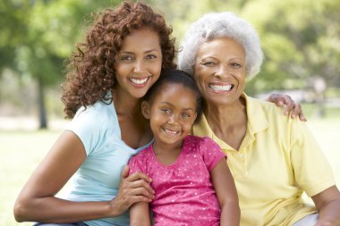 Grandmother With Daughter And Granddaughter In Park clipart