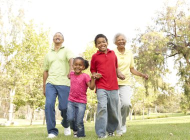 Grandparents In Park With Grandchildren clipart