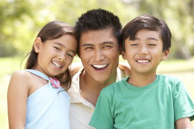 Father With Children In Park clipart