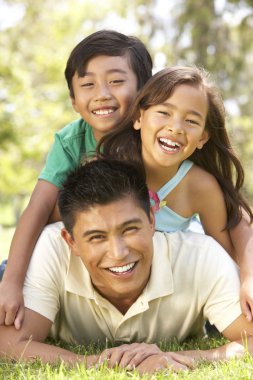 Father And Children Enjoying Day In Park clipart