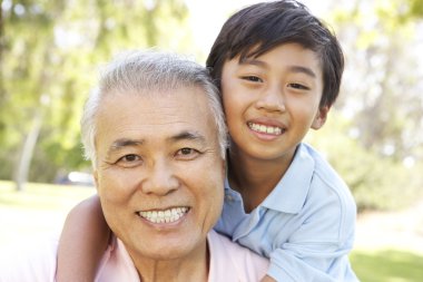 Grandfather With Grandson In Park clipart