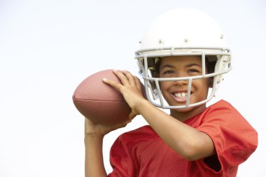 Young Boy Playing American Football clipart