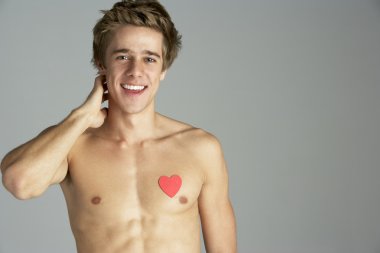 Semi Naked Young Man With Heart Shaped Symbol clipart