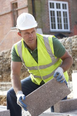 Construction Worker Laying Blockwork clipart