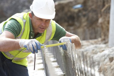 Construction Worker Holding Measure clipart