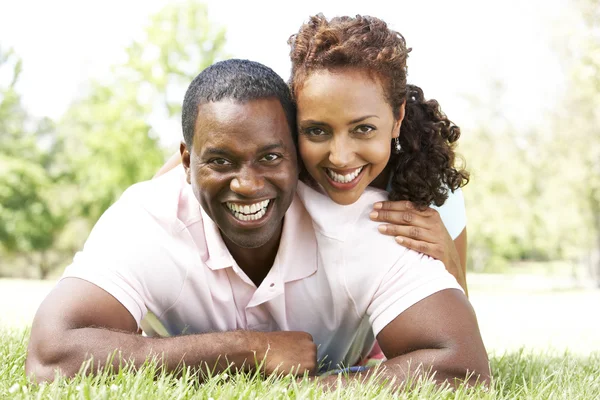 Portrait Of Young Couple Sitting In Park — Stock Photo, Image