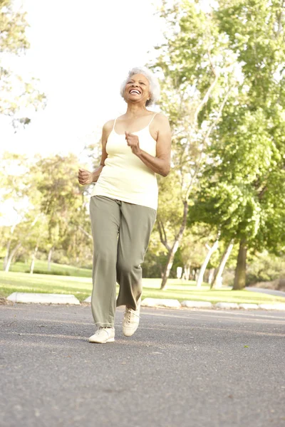 Старшая женщина бегает в парке — стоковое фото