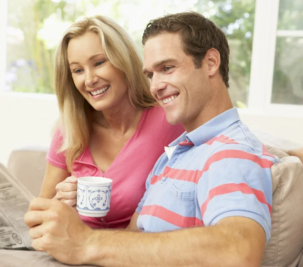 Couple Reading Newspaper At Home — Stock Photo, Image