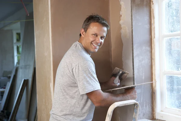 Plasterer Working On Interior Wall Stock Picture
