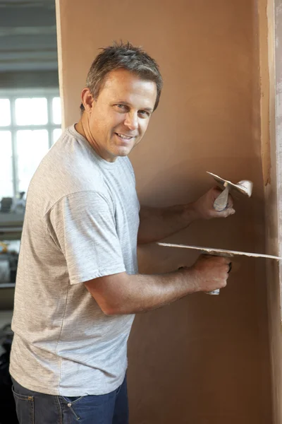 Plasterer Working On Interior Wall Stock Image
