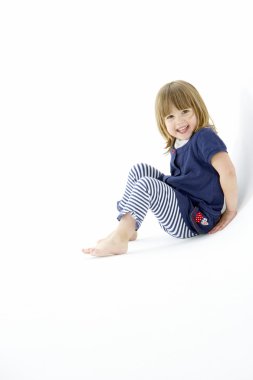 Young Girl Sitting In WhiteStudio clipart