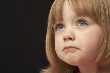 Close Up Studio Portrait Of Sad Young Girl clipart