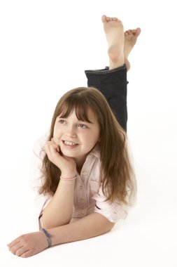 Young Girl Lying On Stomach In Studio clipart