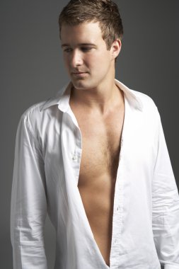 Studio Portrait Of Young Man Wearing Open Shirt clipart