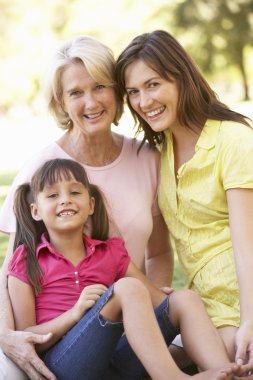 Grandmother With Mother And Daughter In Park clipart