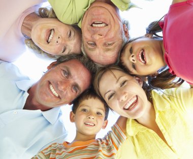 Extended Family Group Looking Down Into Camera clipart