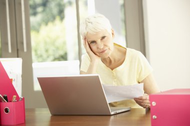 Senior Woman Using Laptop At Home clipart