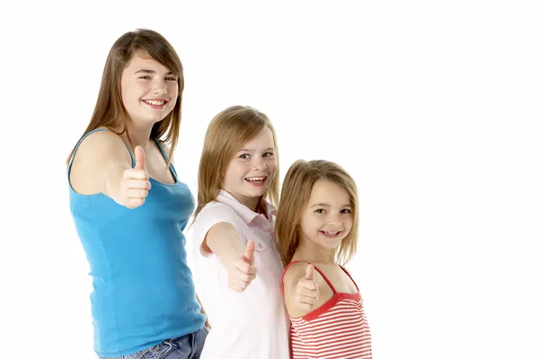 Tres chicas abandonando el gesto de pulgares en el estudio —  Fotos de Stock