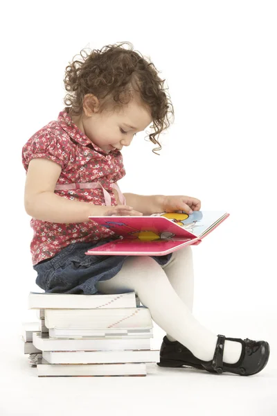 Junges Mädchen Sitzt Auf Bücherstapel Und Liest — Stockfoto
