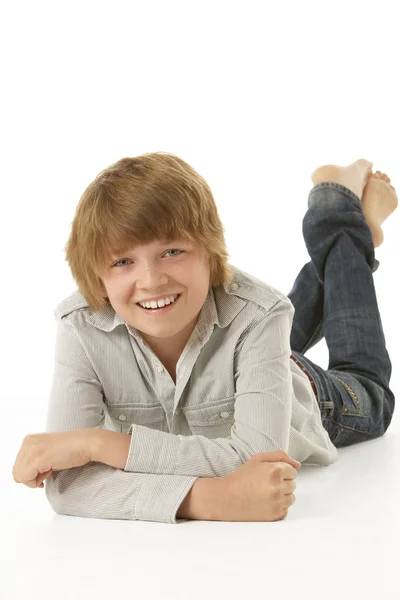 Young Boy Lying On Stomach In Studio — Stock Photo, Image