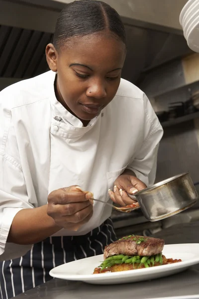 Kocken lägga sås att skålen i restaurangkök — Stockfoto