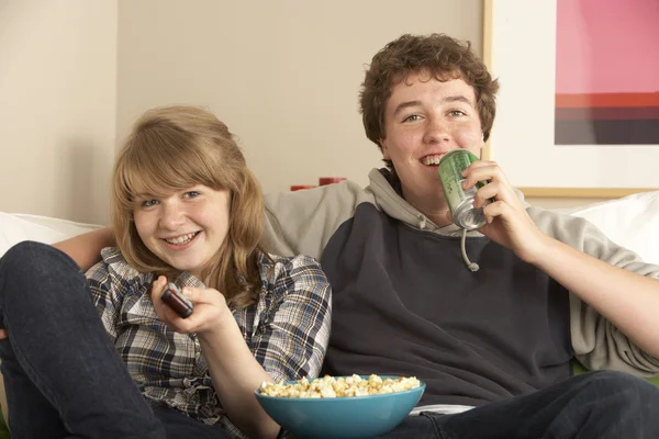 stock image Teenage Couple Sitting On Sofa Watching TV