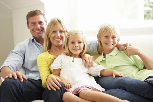 Family Sitting In Living Room Smiling — Stock Photo © Monkeybusiness 