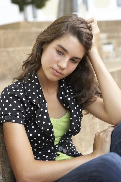Ongelukkig vrouwelijke tiener student zitten buiten op college stappen — Stockfoto