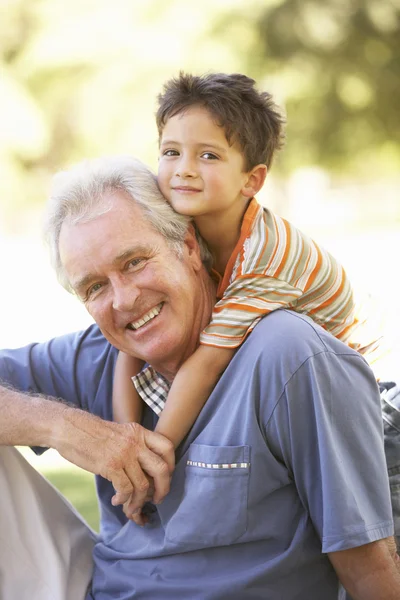 Grandfather Giving Grandson Ride Back Park — Stock Photo, Image
