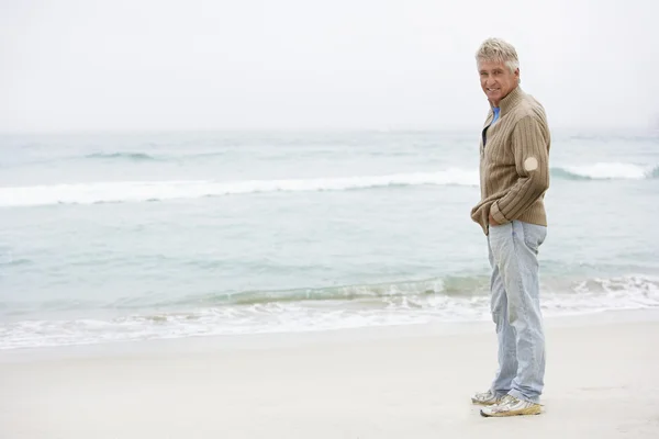 Homme âgé en vacances debout sur la plage d'hiver — Photo