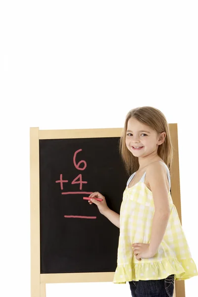 Young Girl Writing On Blackboard Stock Photo