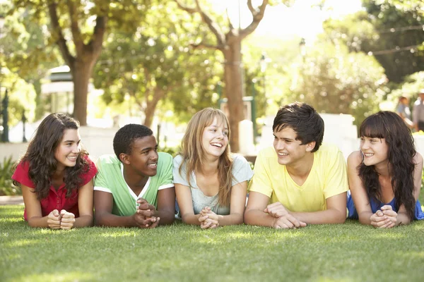 Group Teenagers Lying Stomachs Park Stock Photo