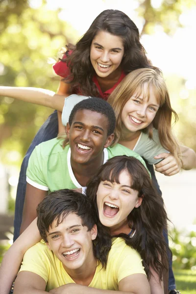 Group Of Teenagers Piled Up In Park Stock Photo
