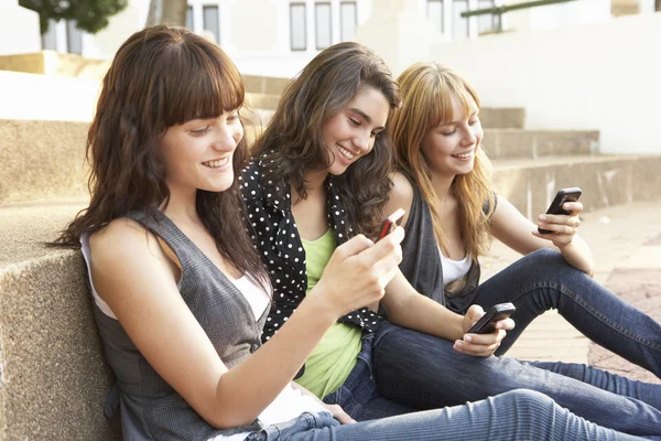 Group Of Teenage Students Sitting Outside On College Steps Using Royalty Free Stock Photos