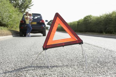 Mother And Daughter Broken Down On Country Road With Hazard Warn clipart