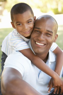 Portrait of Happy Father and Son In Park clipart