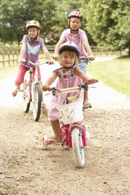 Children In Countryside Wearing Safety Helmets clipart